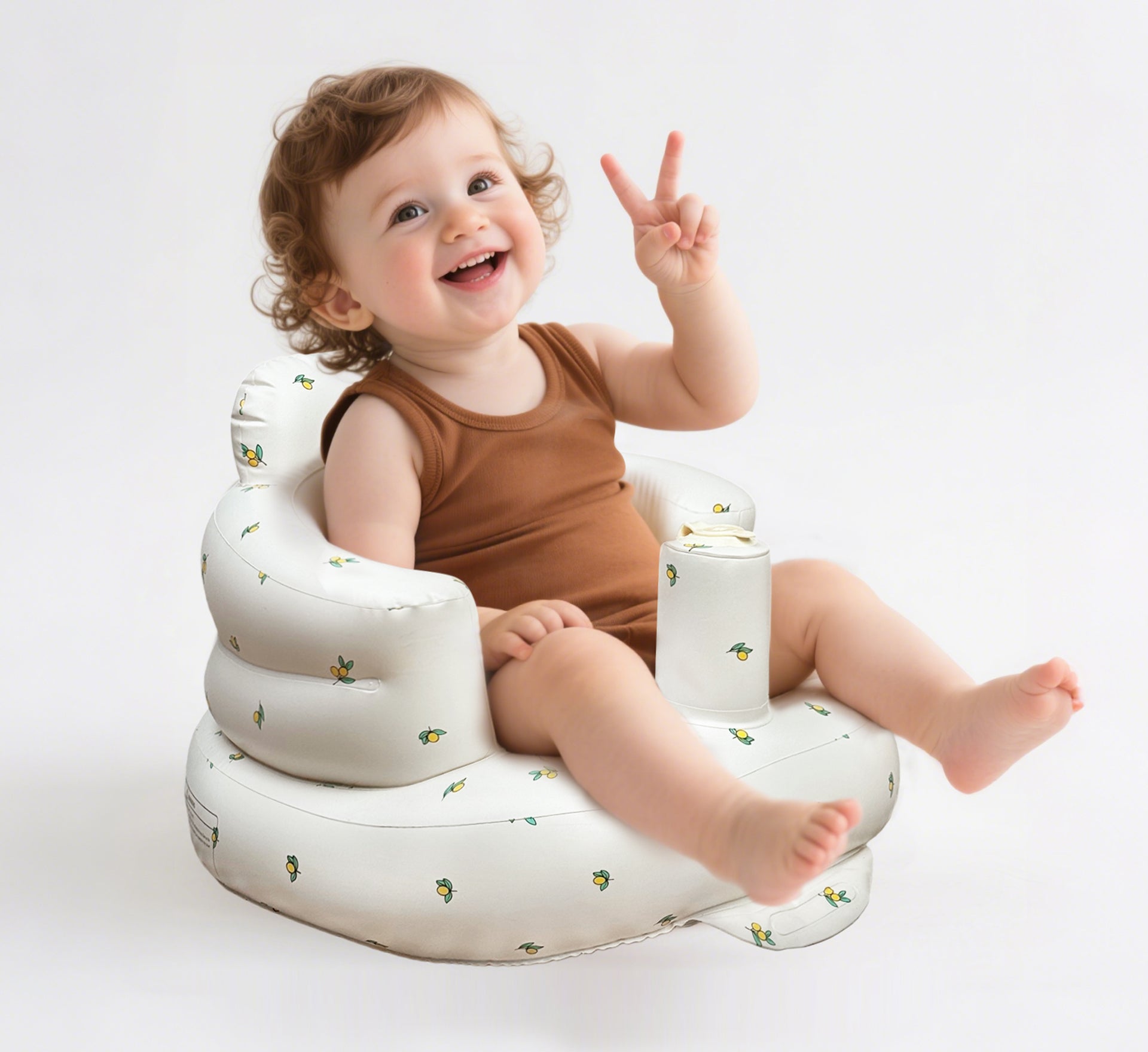 Smiling baby is safely seated in the ComfyBub™ inflatable baby seat with an adorable pattern and a portable - foldable design